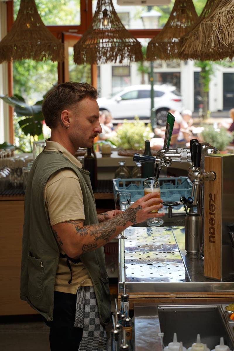 Bartender pouring a drink: hospitality brand content still